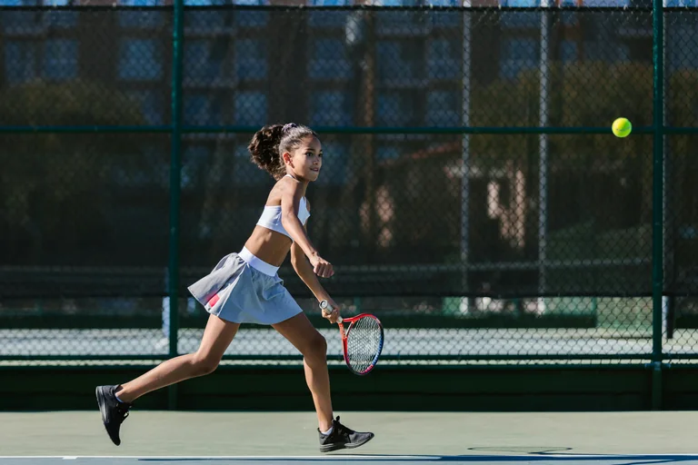 Tennis player training with coach